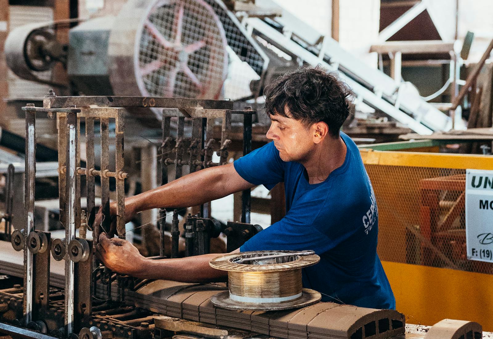 Industrial operator running a production-line machine setup